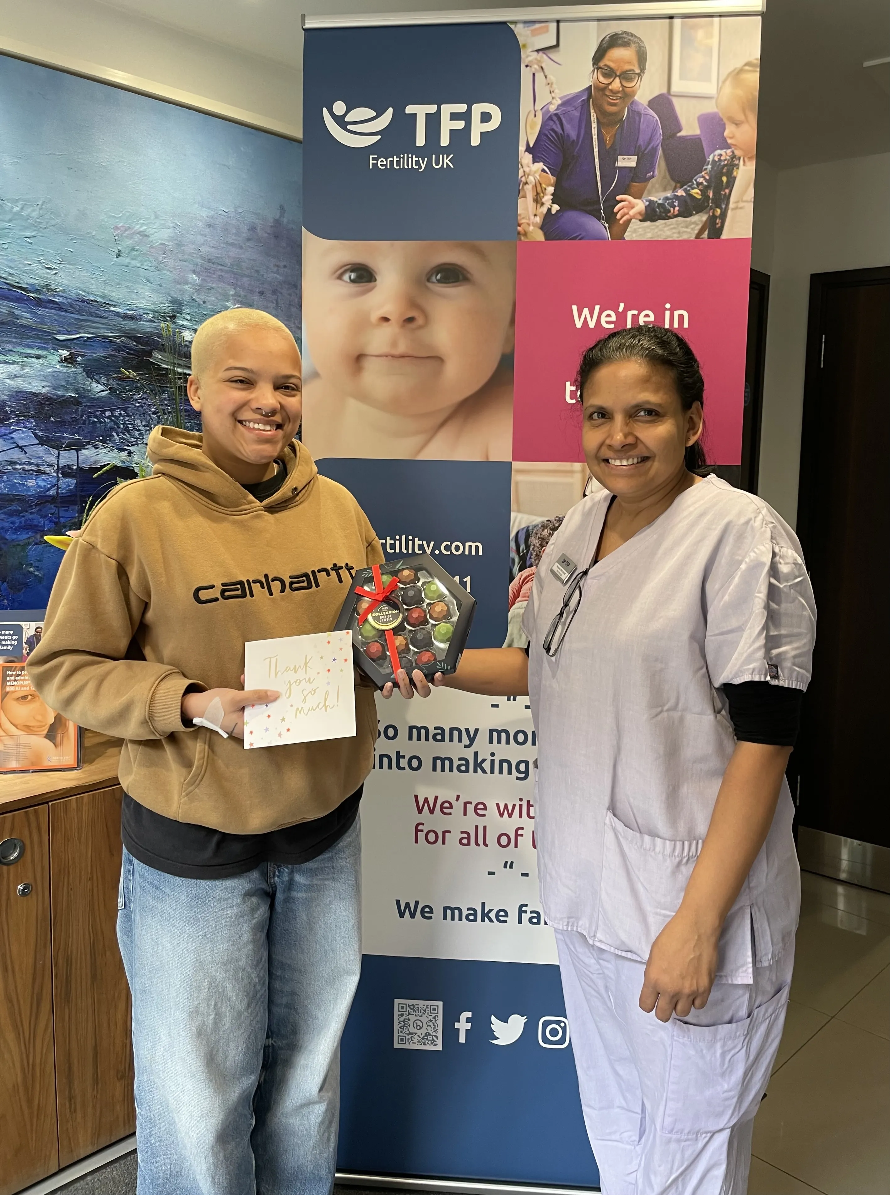 A person stood with a nurse at a fertility clinic