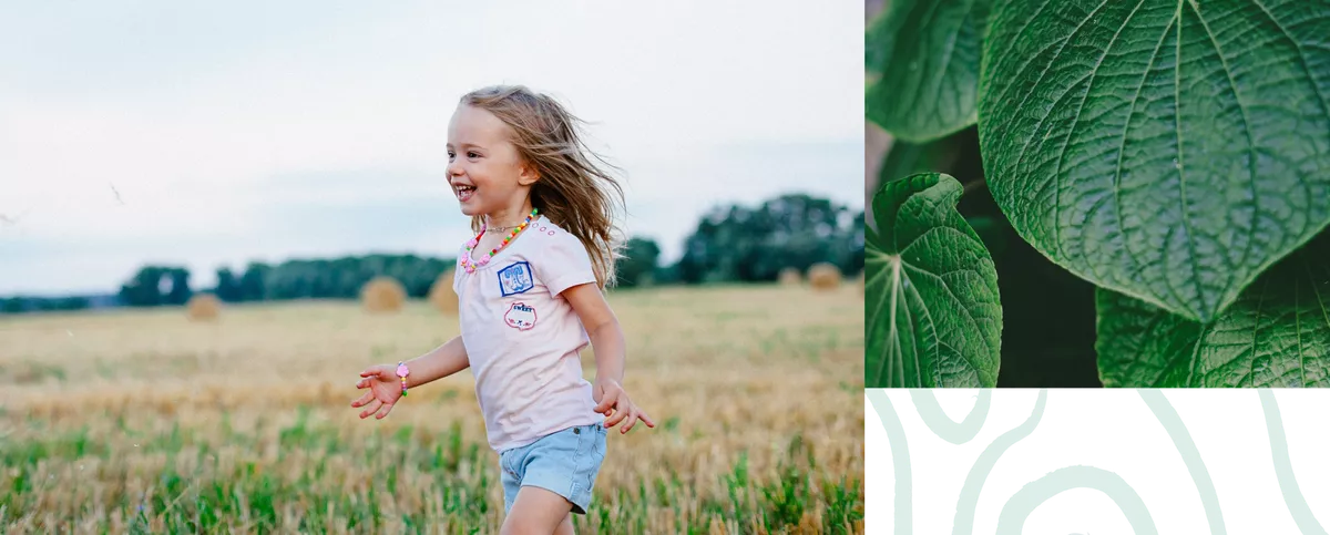 girl running in a field, plants