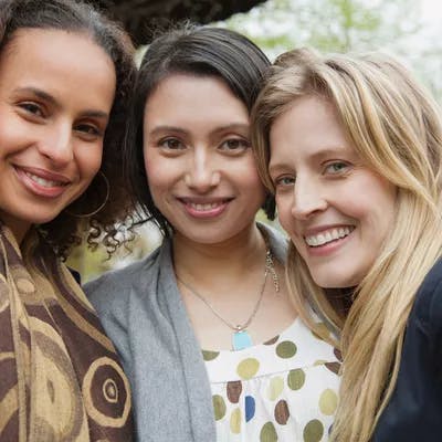 Portrait of three attractive mid-adult woman outside.