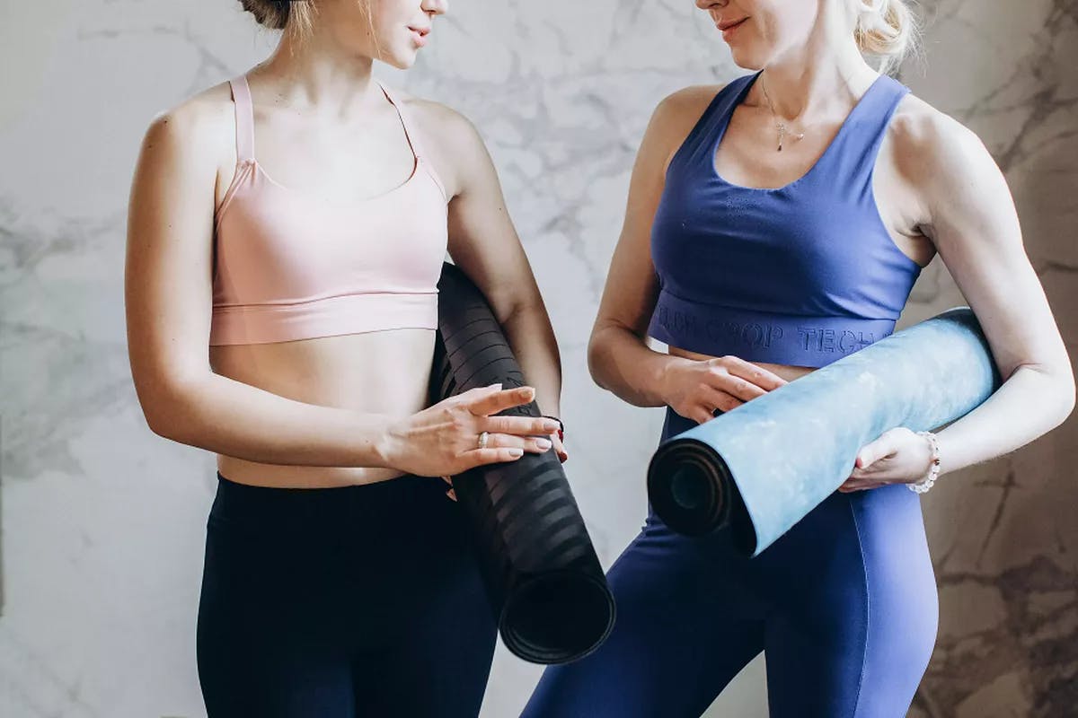 Women holding yoga mats